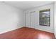 Bedroom with wood-look flooring, a window, and closet with sliding doors at 2750 King Oak Cir, St Cloud, FL 34769
