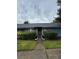 Charming single-story home featuring a brick facade, well-manicured landscaping, and inviting entryway walkway at 2750 King Oak Cir, St Cloud, FL 34769