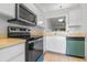 Kitchen boasts functional appliances, bright white cabinets, tile flooring, and pass-through window at 2750 King Oak Cir, St Cloud, FL 34769