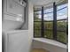 Laundry room features a stacked washer/dryer unit and bright window at 2750 King Oak Cir, St Cloud, FL 34769