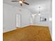 Bright living room with ceiling fan, open layout, and a pass-through to the kitchen at 2750 King Oak Cir, St Cloud, FL 34769