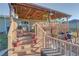 Inviting covered back deck with a wood ceiling, string lights, and potted plants, perfect for outdoor entertaining at 2801 Sw 139Th St, Ocala, FL 34473
