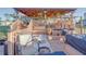 Cozy covered back deck featuring an outdoor seating area, potted plants, and access to a serene backyard at 2801 Sw 139Th St, Ocala, FL 34473