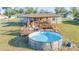 Backyard featuring a multi-level deck with outdoor seating and an above ground pool for summer fun at 2801 Sw 139Th St, Ocala, FL 34473