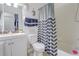 Clean bathroom featuring a shower with a decorative curtain and a white vanity at 2801 Sw 139Th St, Ocala, FL 34473