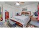 Comfortable bedroom with a queen-size bed, ceiling fan, and ample natural light at 2801 Sw 139Th St, Ocala, FL 34473