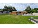 A well-maintained backyard with a concrete patio and lawn furniture at 331 Greens End St, Orlando, FL 32810