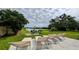 Relaxing backyard features multiple lounge chairs, patio seating, and peaceful water views at 331 Greens End St, Orlando, FL 32810