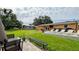 Large backyard with a concrete patio, lounge chairs, and green space at 331 Greens End St, Orlando, FL 32810