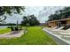 Large backyard featuring patio, lounge chairs, outdoor seating, and access to the lake at 331 Greens End St, Orlando, FL 32810
