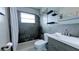 This bathroom has modern gray tile work and a gray vanity at 331 Greens End St, Orlando, FL 32810