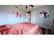 Bedroom with wood-look floors, a ceiling fan, and modern art at 331 Greens End St, Orlando, FL 32810