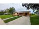 View of house with driveway and walkway, showcasing the landscaping and ample parking space at 331 Greens End St, Orlando, FL 32810