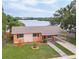 Inviting waterfront home featuring a well-maintained lawn and a convenient carport at 331 Greens End St, Orlando, FL 32810
