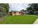 A quaint home with a well-maintained front lawn, decorative plants, and a classic design at 331 Greens End St, Orlando, FL 32810