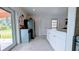 Bright and airy kitchen showcasing white cabinetry, stainless steel appliances, and an open layout at 331 Greens End St, Orlando, FL 32810