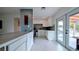 A bright kitchen featuring modern white cabinets, stainless appliances, and elegant tile flooring at 331 Greens End St, Orlando, FL 32810