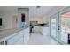 Bright kitchen with white cabinets, stainless steel appliances, and marble countertops and flooring at 331 Greens End St, Orlando, FL 32810