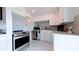 Modern kitchen featuring stainless steel appliances, sleek countertops, and stylish white cabinetry at 331 Greens End St, Orlando, FL 32810