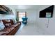Cozy living room featuring a comfortable sofa, accent chair, and plenty of natural light at 331 Greens End St, Orlando, FL 32810