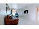 Inviting living room with a stylish leather sofa, modern accents, and a large window at 331 Greens End St, Orlando, FL 32810