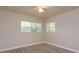 Serene bedroom featuring wood-look floors and ample natural light from two windows at 3524 Amigos Ave, Orlando, FL 32808