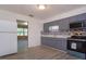 Efficient kitchen featuring stainless steel appliances, modern countertops, and wood-look floors at 3524 Amigos Ave, Orlando, FL 32808