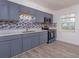 Efficient kitchen featuring stainless steel appliances, modern countertops, and wood-look floors at 3524 Amigos Ave, Orlando, FL 32808