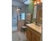 Bathroom with a glass enclosed shower, tiled walls, vanity with storage and a comfortable chair at 361 Dreama Dr, Davenport, FL 33897
