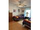 Bedroom featuring two twin beds, and wooden dresser in a brightly lit room with cartoon decor at 361 Dreama Dr, Davenport, FL 33897