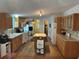Traditional kitchen with tile backsplash, island, and wood cabinets providing lots of storage at 361 Dreama Dr, Davenport, FL 33897