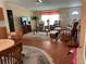 Bright and open living space with hardwood floors adjoining the dining and kitchen areas at 361 Dreama Dr, Davenport, FL 33897