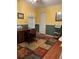 Office with laminate floor, color block walls, wooden desk, and patterned area rug at 361 Dreama Dr, Davenport, FL 33897