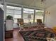 Enclosed sunroom with tile flooring, comfortable seating, and plenty of natural light from surrounding windows at 361 Dreama Dr, Davenport, FL 33897