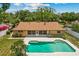 Aerial shot of backyard featuring inground pool and outdoor living space with screened porch at 3942 Orange Lake Dr, Orlando, FL 32817