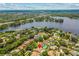 Stunning aerial view highlights the property's ideal location near a lake and lush tree canopy at 3942 Orange Lake Dr, Orlando, FL 32817
