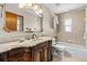 Bathroom showcasing decorative vanity with marble countertop, tiled walls, and bath tub at 3942 Orange Lake Dr, Orlando, FL 32817