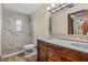 Bathroom featuring custom vanity, dual sinks, a tile shower, and natural light at 3942 Orange Lake Dr, Orlando, FL 32817
