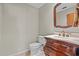 Elegant powder room featuring a carved wood vanity with marble countertop and classic fixtures at 3942 Orange Lake Dr, Orlando, FL 32817
