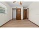 A bedroom showcasing wood-look floors, closet space, and a neatly closed door, all in neutral tones at 3942 Orange Lake Dr, Orlando, FL 32817