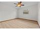 Bright bedroom features light wood flooring, a window, and a ceiling fan at 3942 Orange Lake Dr, Orlando, FL 32817