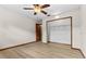 Spacious bedroom offers light wood flooring, a closet, and a ceiling fan at 3942 Orange Lake Dr, Orlando, FL 32817