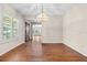 Bright dining room with hardwood floors, natural light, and decorative chandelier at 3942 Orange Lake Dr, Orlando, FL 32817
