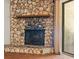 Close up of a stone fireplace with raised hearth and sliding door to patio at 3942 Orange Lake Dr, Orlando, FL 32817