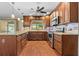 Well-lit kitchen with stainless appliances, granite counters, and wood cabinets at 3942 Orange Lake Dr, Orlando, FL 32817