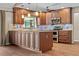 Open-concept kitchen island with stainless appliances, granite counters, and wood cabinets at 3942 Orange Lake Dr, Orlando, FL 32817