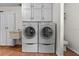 Functional laundry area with washer, dryer, storage cabinets, and a utility sink at 3942 Orange Lake Dr, Orlando, FL 32817
