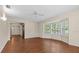 Open-concept living room area with wood floors and bay windows with plantation shutters at 3942 Orange Lake Dr, Orlando, FL 32817