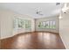 Bright living room area with wood floors, bay windows with shutters, and neutral walls at 3942 Orange Lake Dr, Orlando, FL 32817