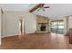 Cozy living room with stone fireplace, hardwood floors, and access to outdoor space at 3942 Orange Lake Dr, Orlando, FL 32817